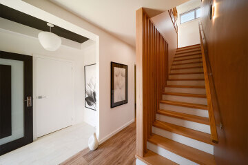 Featured recessed ceiling entrance and timber stairs
